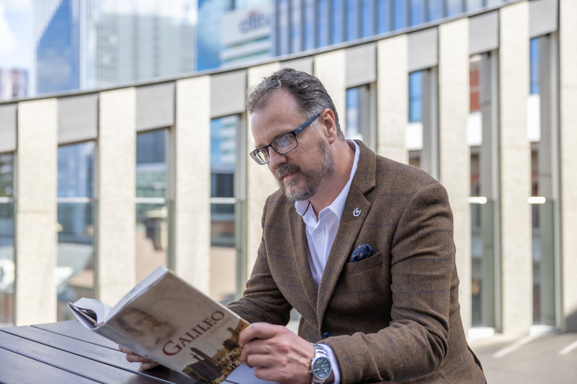 Juan reading a Galileo biography on a Perth rooftop