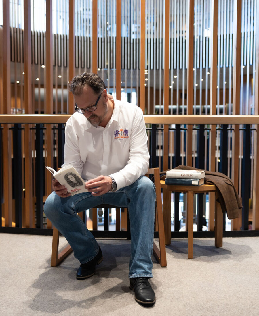 Juan, The Prof, reading in a library
